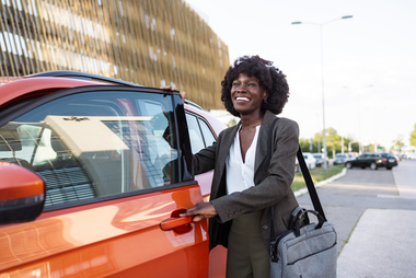Business professional getting into car for work travel and mileage tracking