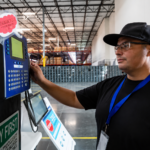 Employee clocking in at time clock