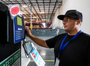 Employee clocking in at time clock